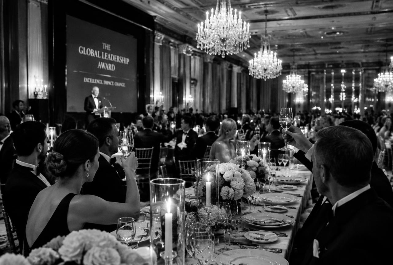 Awards gala dinner with chandeliers and guests toasting