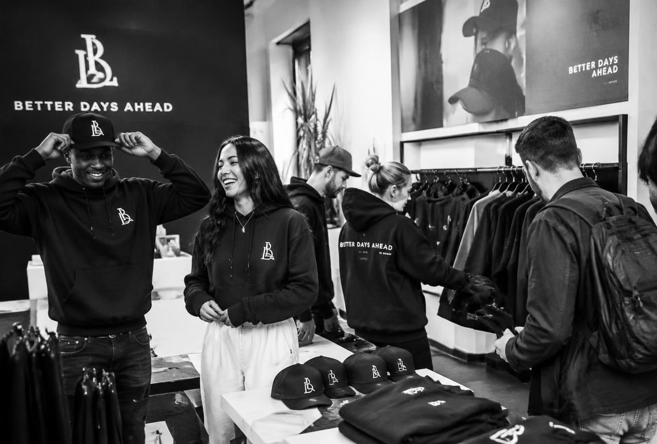 Community members trying on custom event merch