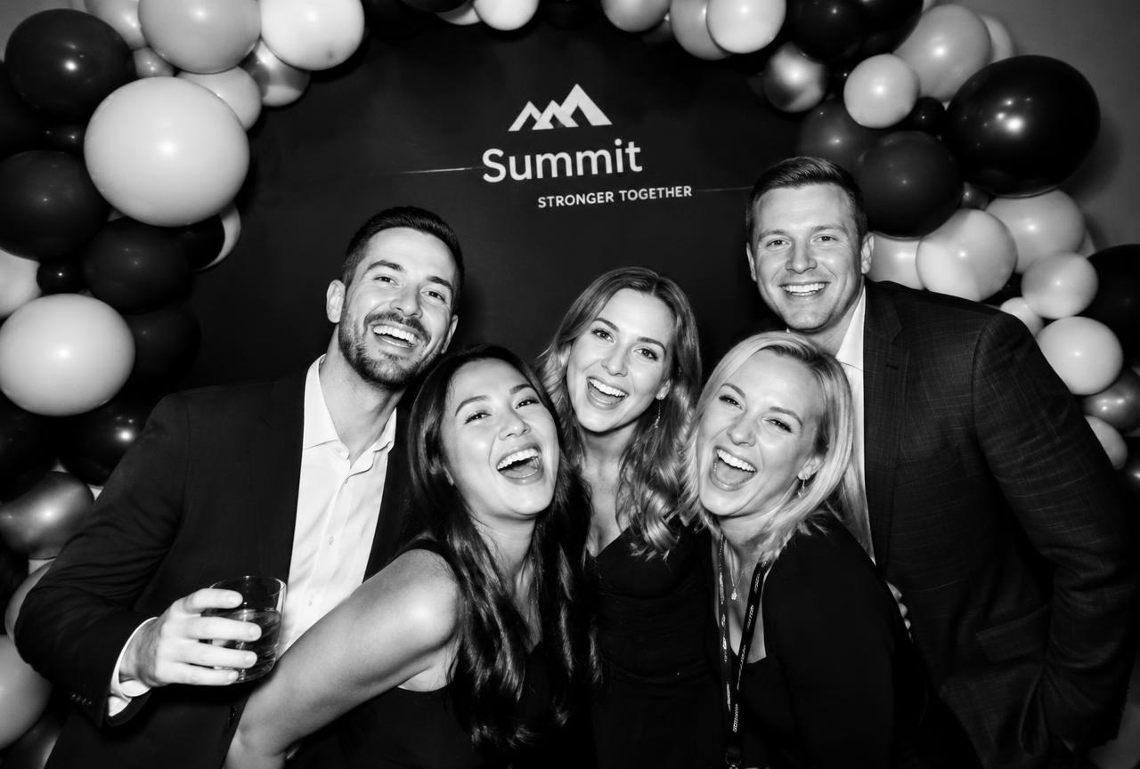 Attendees posing at a balloon photo moment