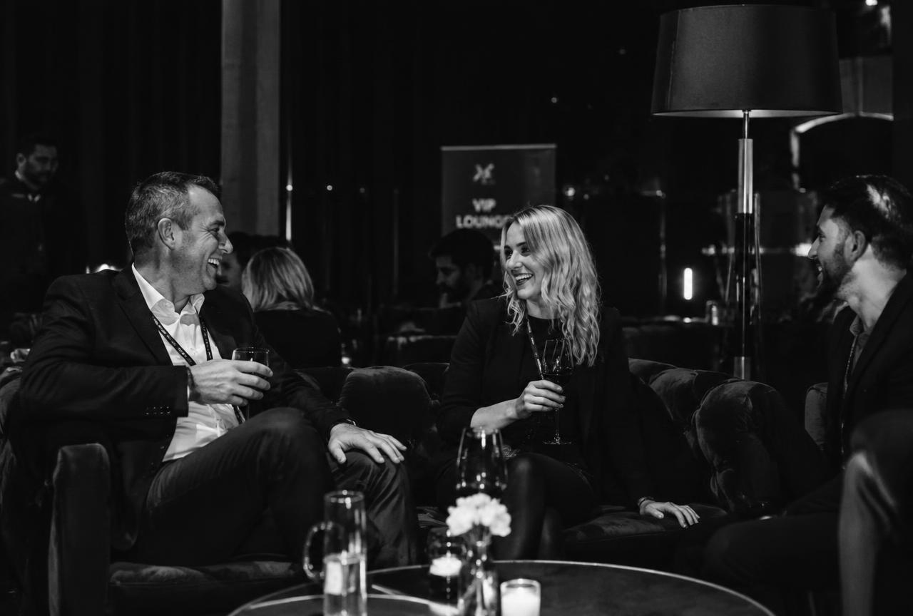VIP lounge with attendees laughing